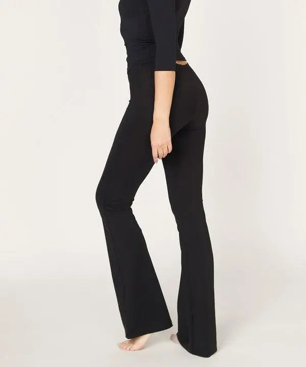 Woman wearing black BAMBOO SLIM BELL yoga pants with a slim fit and slight flare at the bottom